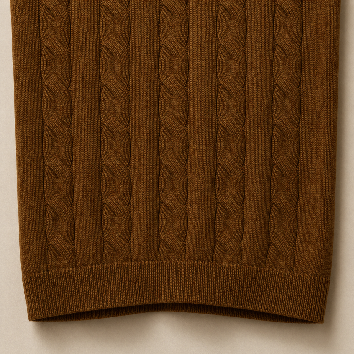 Close-up of the 100% cotton fabric and bottom hem stitching on the Men's Brown Cable Knit Polo by Juliet Parkar