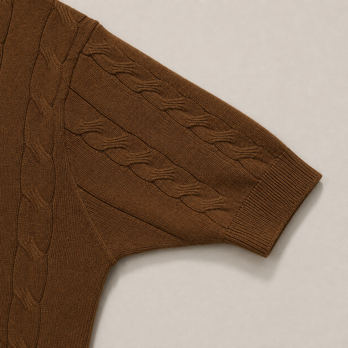 Close-up of the short sleeve with ribbed cuff on the Men's Brown Cable Knit Polo in 100% cotton by Juliet Parkar