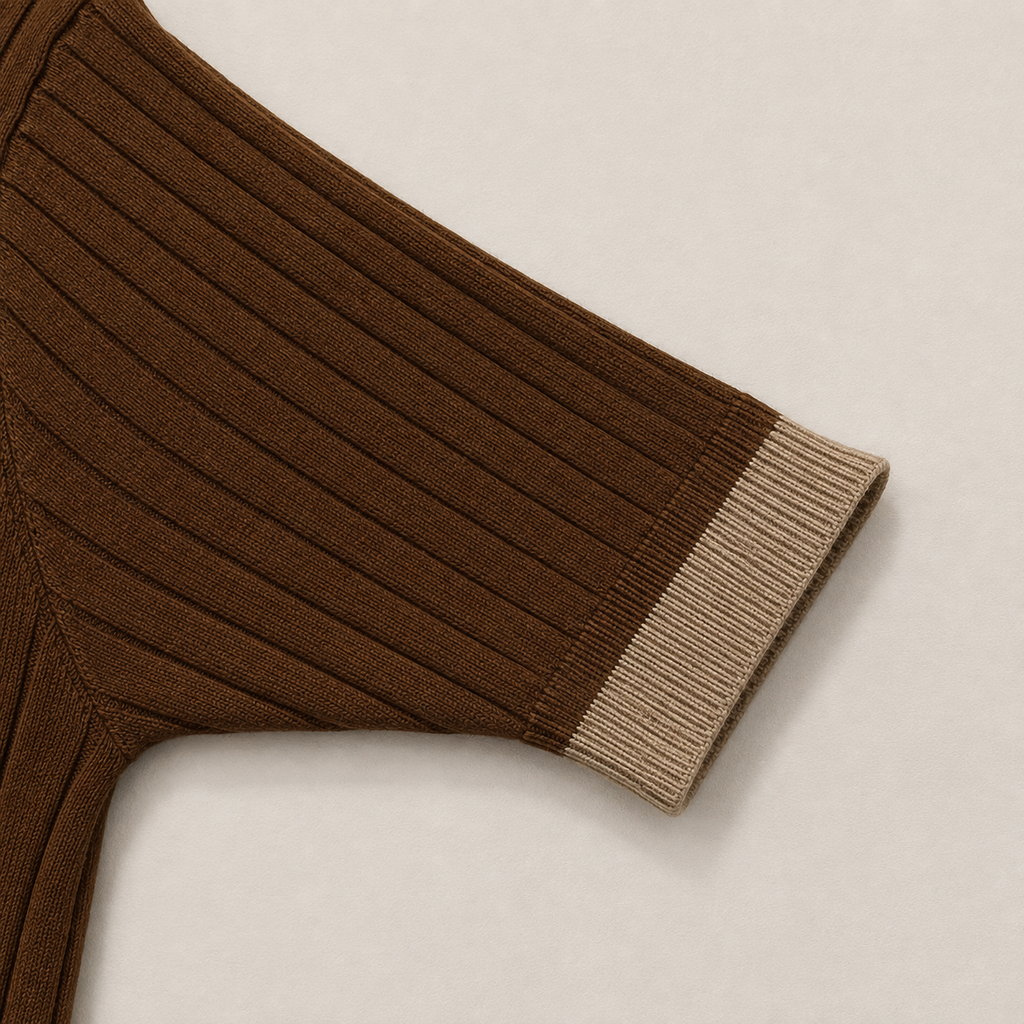 Close-up of the short sleeve with ribbed cuff on the Men's Brown Contrast Collar Polo in 100% cotton by Juliet Parkar