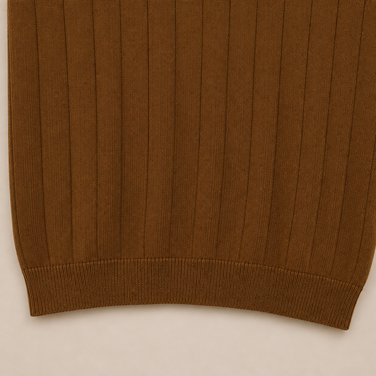 Close-up of the 100% cotton fabric and bottom hem stitching on the Men's Brown Rib Knit Polo by Juliet Parkar