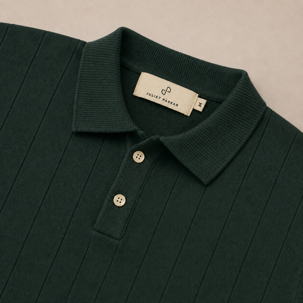 Close-up of the collar and button placket on the Men's Forest Green Rib Knit Polo in 100% cotton by Juliet Parkar