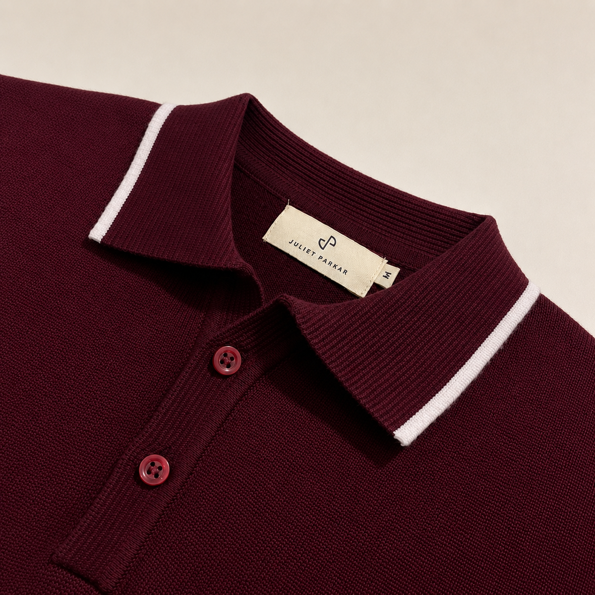 Close-up of the collar and button placket on the Men's Maroon Classic Polo in 100% cotton piqué by Juliet Parkar