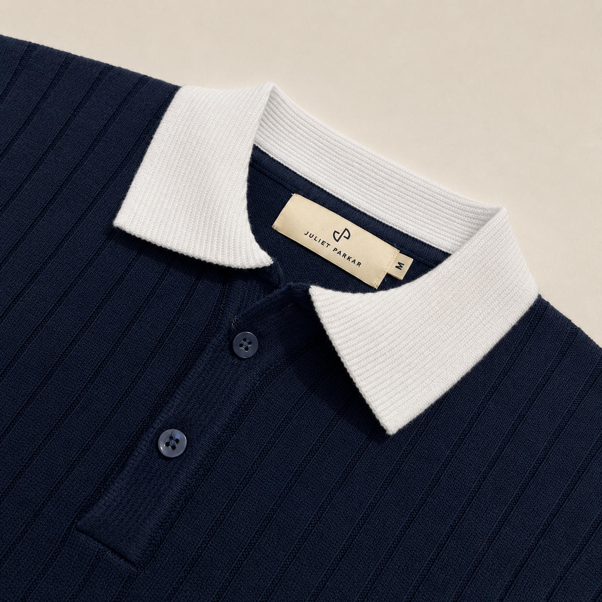Close-up of the collar and button placket on the Men's Navy Blue COntrast Collar Polo in 100% cotton by Juliet Parkar