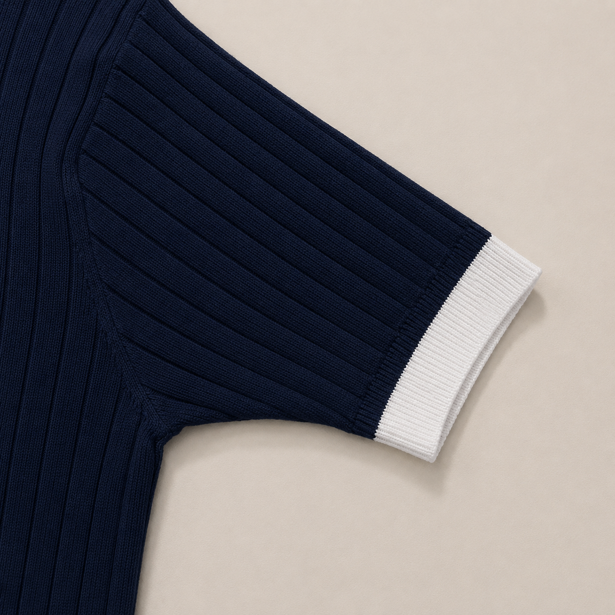 Close-up of the short sleeve with ribbed cuff on the Men's Navy Blue Contrast Collar Polo in 100% cotton by Juliet Parkar