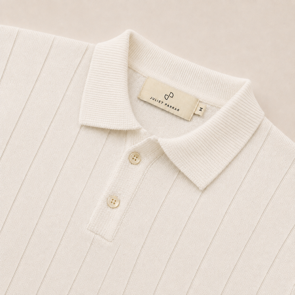 Close-up of the collar and button placket on the Men's Pearl White Rib Knit Polo in 100% cotton by Juliet Parkar