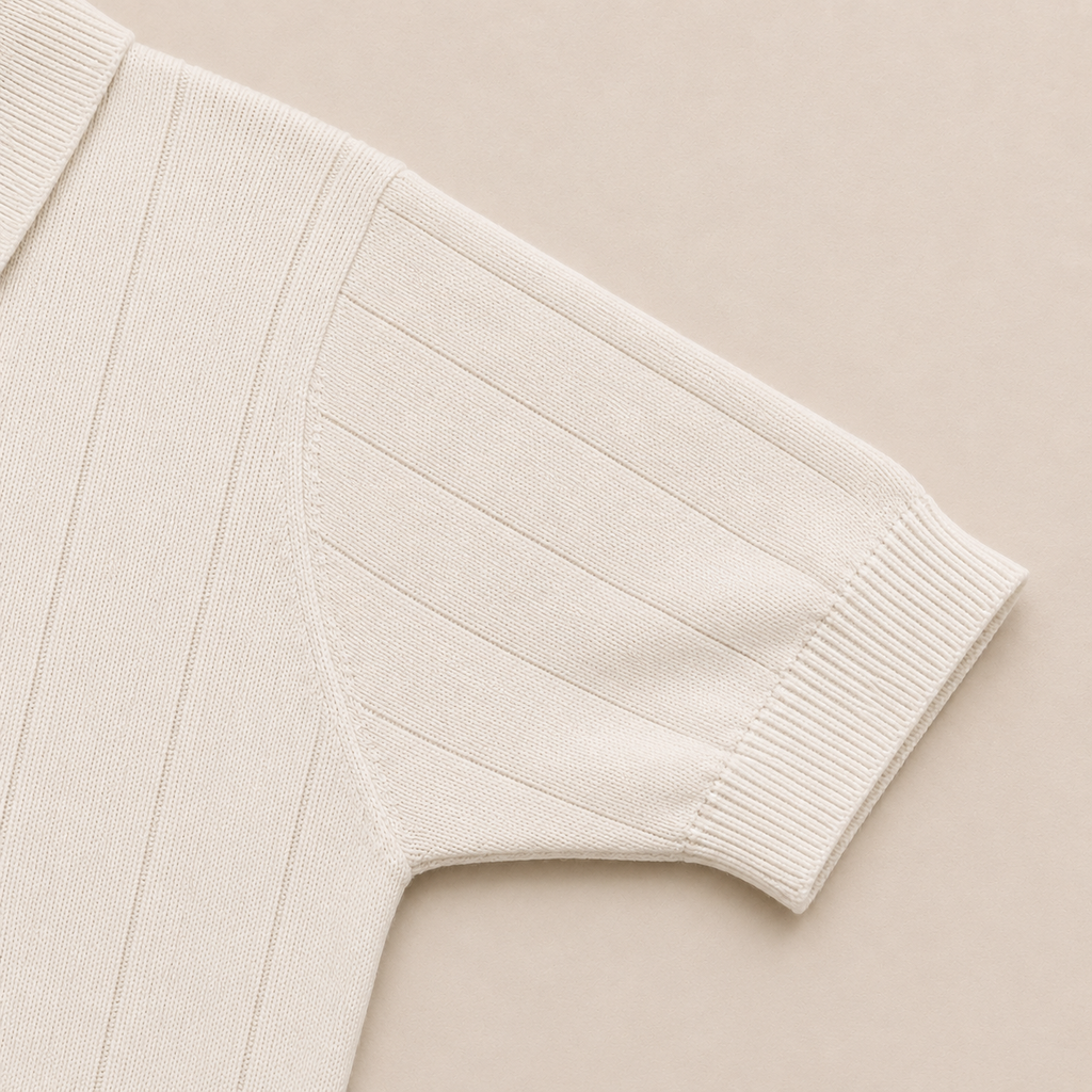 Close-up of the short sleeve with ribbed cuff on the Men's Pearl White Rib Knit Polo in 100% cotton by Juliet Parkar